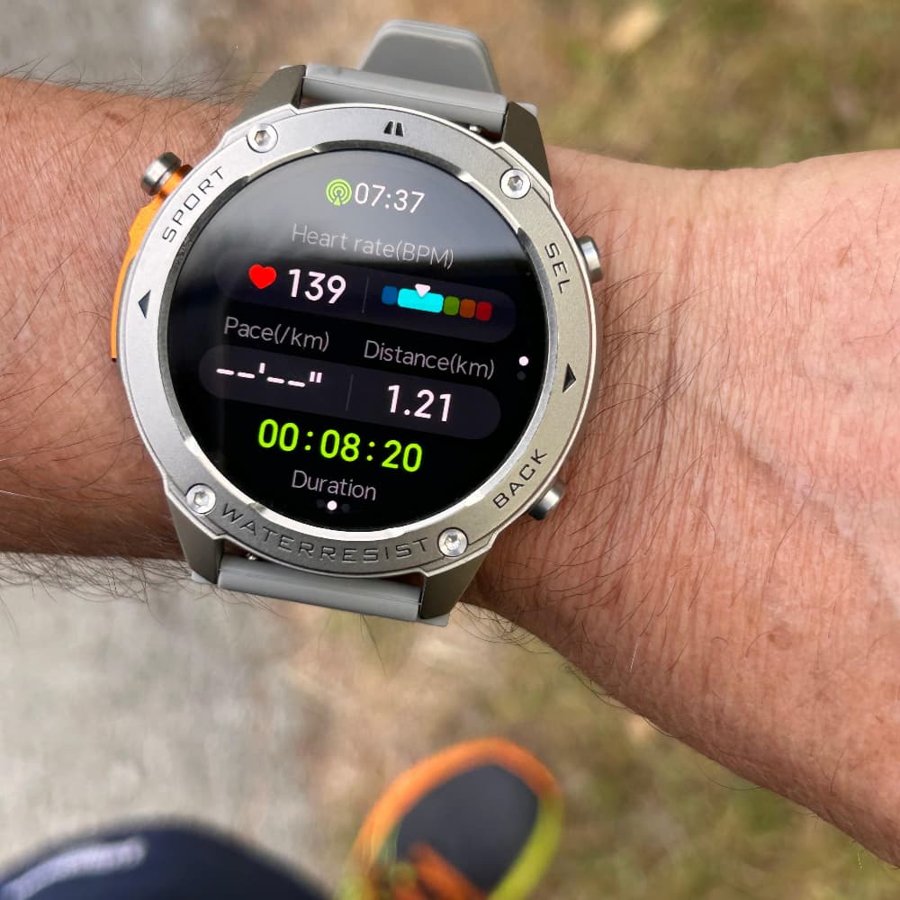 Smartwatch on a person's wrist with fitness tracking display outdoors